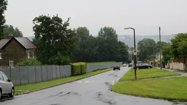 A residential street of stone-built houses on Heaton Park Drive in Bradford