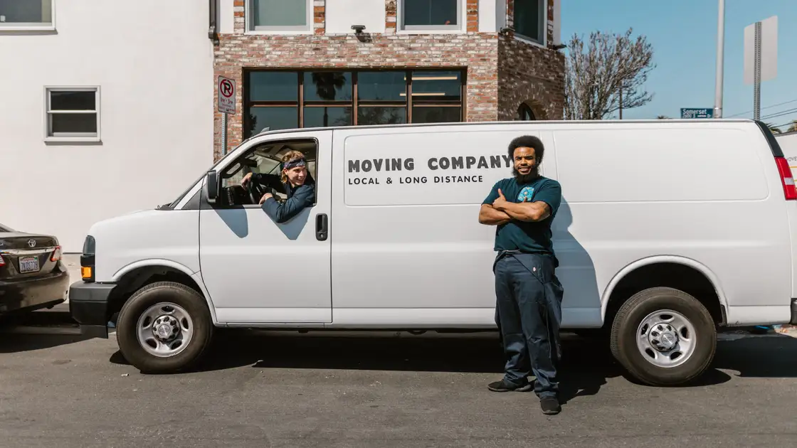 Professional removals crew loading a van for a London house move