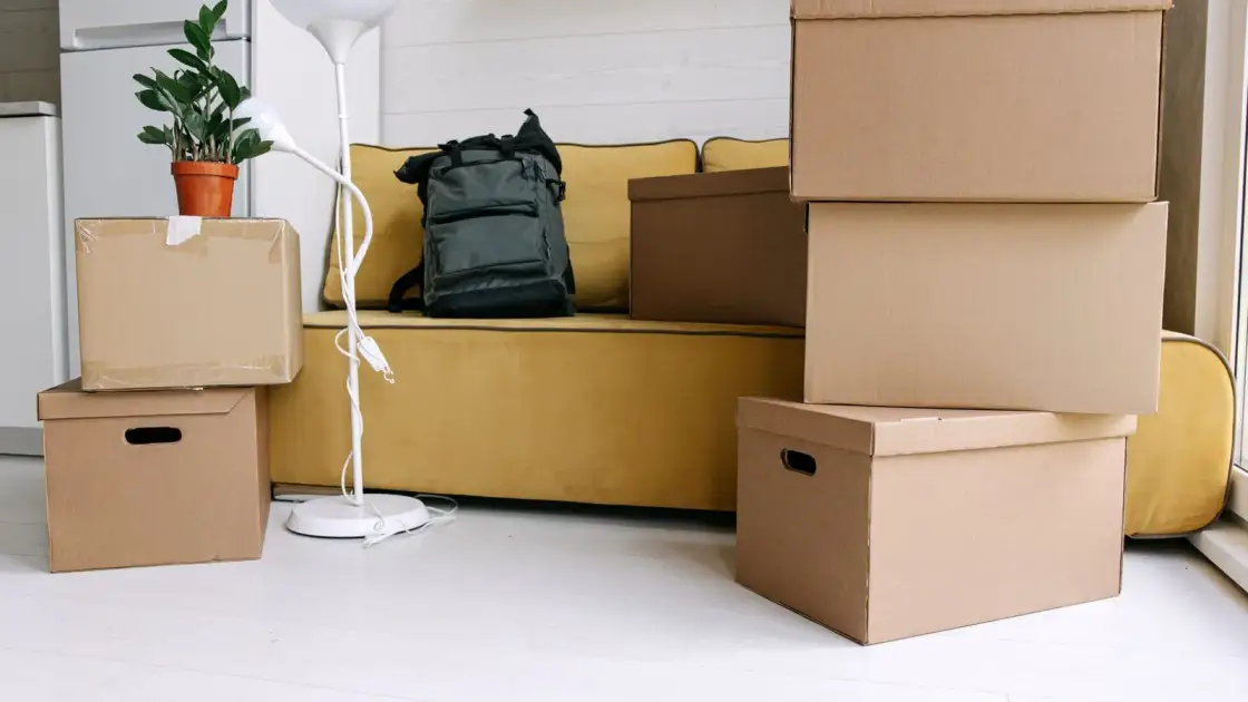 Packed cardboard boxes stacked in a living room ready for a move
