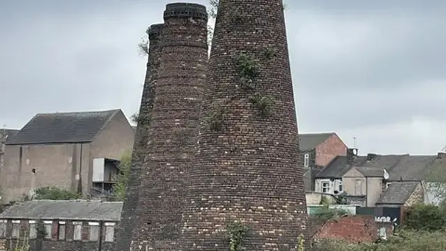 Surviving bottle kiln chimneys rising above rooftops in Burslem, Stoke-on-Trent